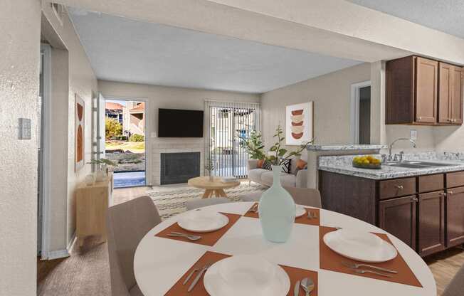 a kitchen and dining room with a table and chairs