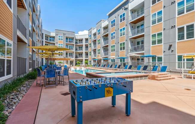 play a game of foosball at the reserve at south coast apartments