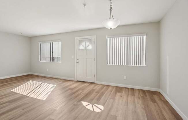A room with a wooden floor and a white door.