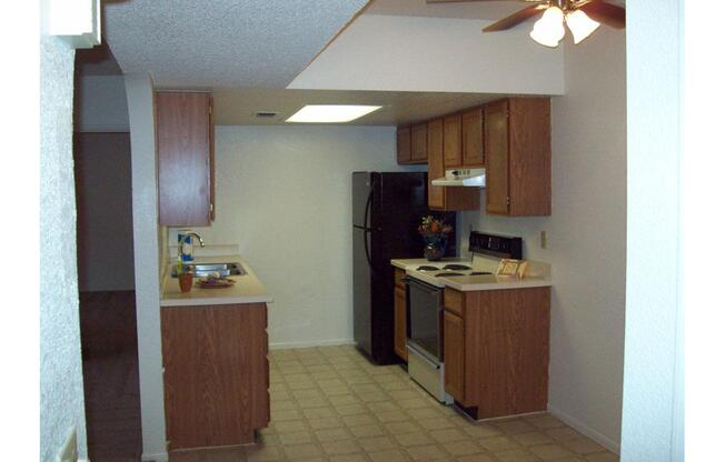 a kitchen with a sink and a refrigerator