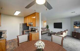 A kitchen with a table and chairs in the foreground.