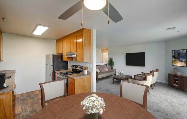 A kitchen with a table and chairs in the foreground.