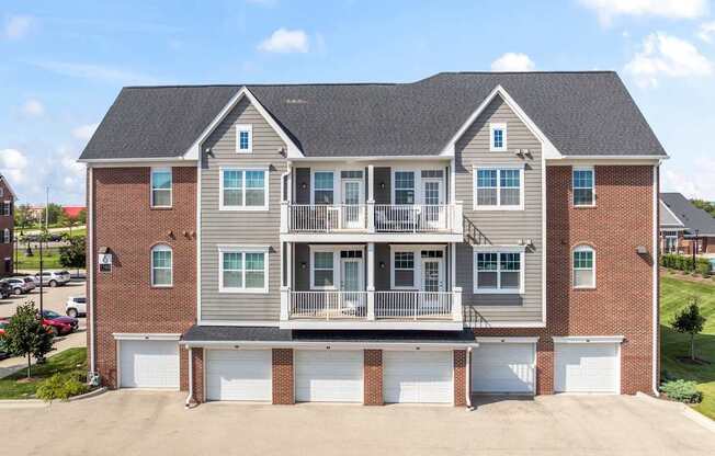 A large two-story house with a garage on the ground floor.