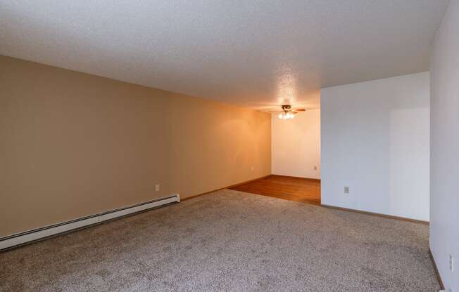 the living room and dining room of an empty apartment. Fargo, ND Country Edge Apartments