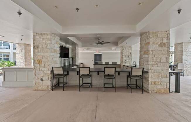 A spacious room with a stone wall and a long table set for six.