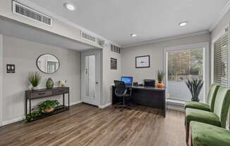 a home office with a desk and a chair and a window