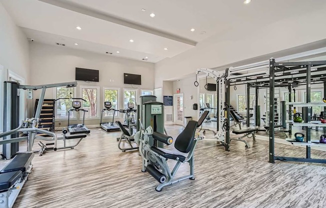 A spacious gym with a variety of equipment including treadmills, weights, and exercise machines.