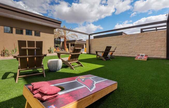 A backyard with a table and chairs and a slide.