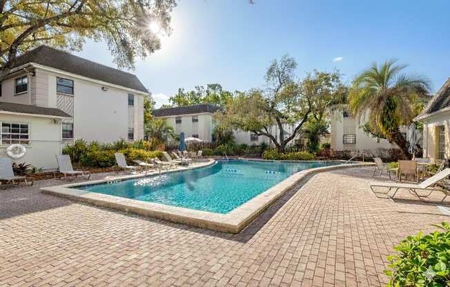 A sunny day at a poolside with a clear blue sky.