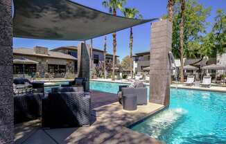 resort-inspired, covered lounging area and swimming pool at Avora apartments