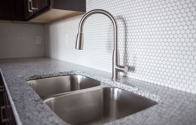 a kitchen sink with a faucet in a 555 waverly unit