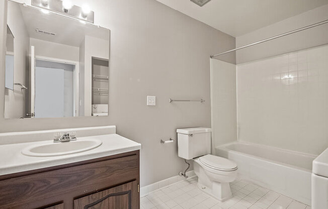 a bathroom with a sink toilet and a mirror