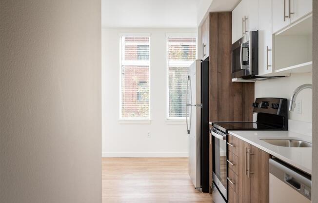 an empty kitchen with a sink and a refrigerator