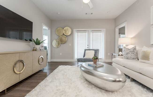 a living room with a white rug and a white couch