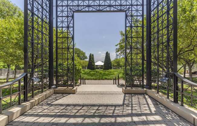 the entrance to a park with a metal structure and stairs at North Harbor Tower, Chicago