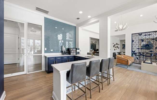 a communal kitchen with a white counter top and blue cabinets