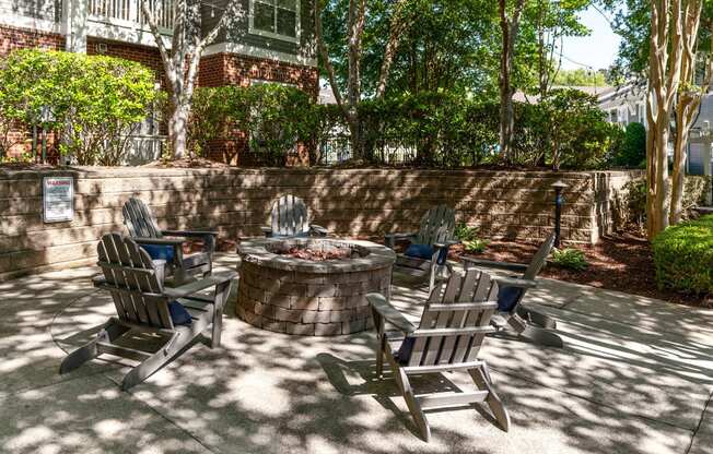 a patio with chairs around a fire pit