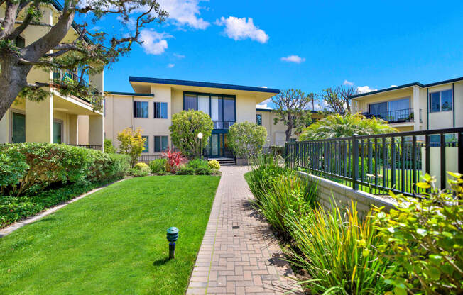 a house with a yard and a walkway in front of it at Casa Del Amo Apartments, California