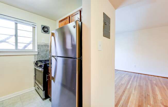 kitchen with stainless steel appliances and wood cabinetry at cambridge square apartments in bethesda md