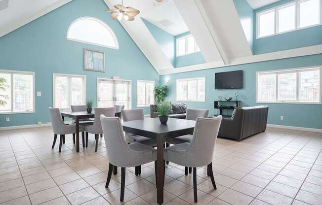 A dining room with a table and chairs.