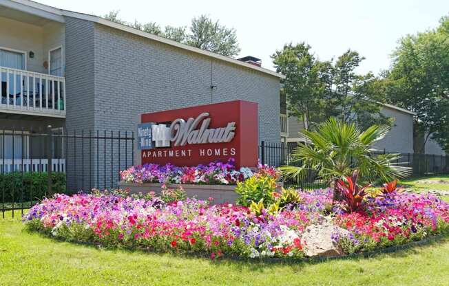 a bed of flowers in front of a building