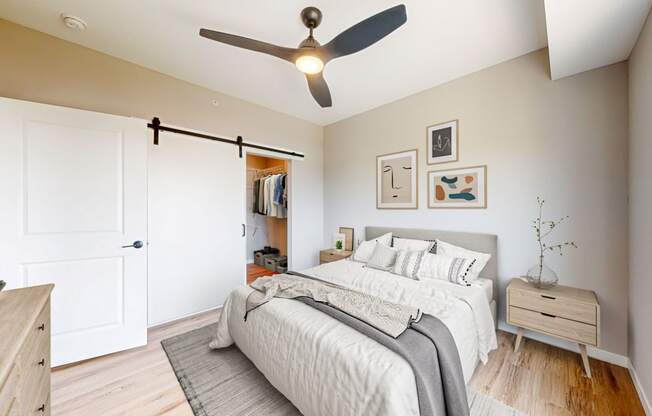 a bedroom with a bed and a ceiling fan