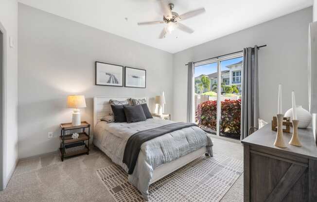 a bedroom with a bed and a ceiling fan