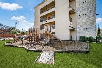 a childrens playground in front of a building