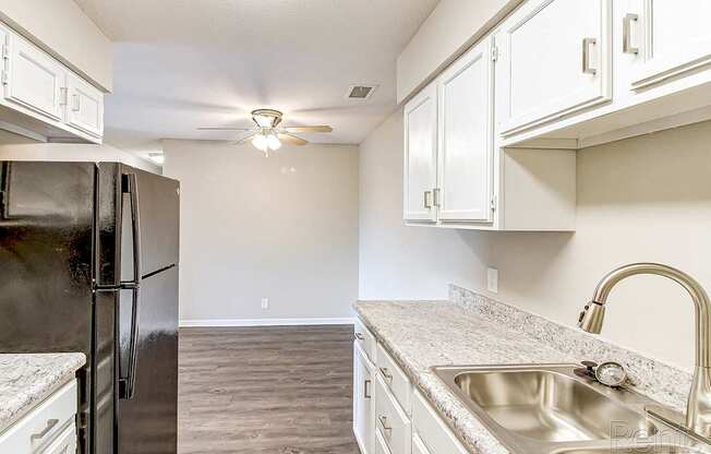 a kitchen with stainless steel appliances and white cabinets