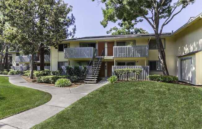 Apartment complex with a green lawn in front.