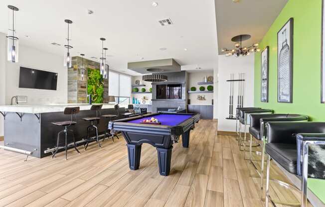 a game room with a pool table and bar