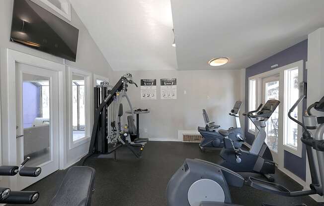 A spacious home gym with a variety of exercise equipment.