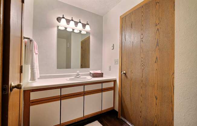 Bathroom with sink and mirror at Park Place Apartments in Fargo, ND