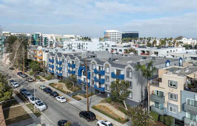 A street view of a residential area with cars parked on the side of the road.