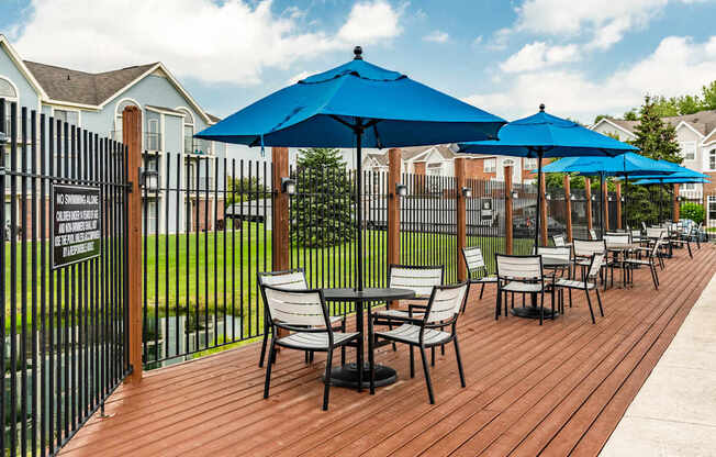 A wooden deck with chairs and umbrellas