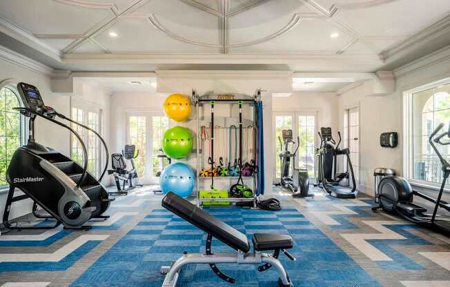 Spacious fitness center with stair climber, free weights, and functional training equipment.