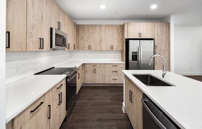 A modern kitchen with wooden cabinets and stainless steel appliances.