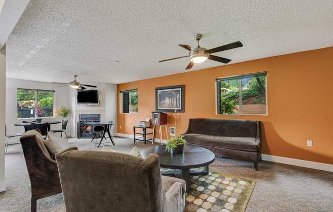 a living room with couches and a table and a ceiling fan at Eagles Landing Apartments, Everett, WA