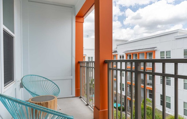 A balcony with a chair and table.