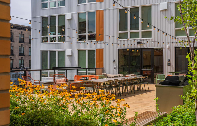 The Warren Apartments patio with dining and hanging lights