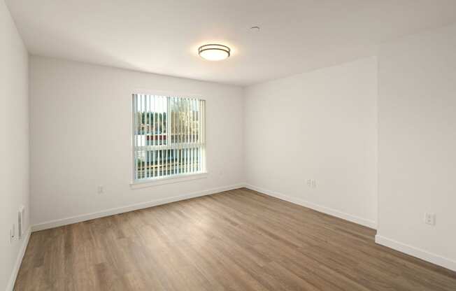 Spacious floor plan with large window and hardwood floors at POLARIS AT SEATAC, SEATAC, 98188
