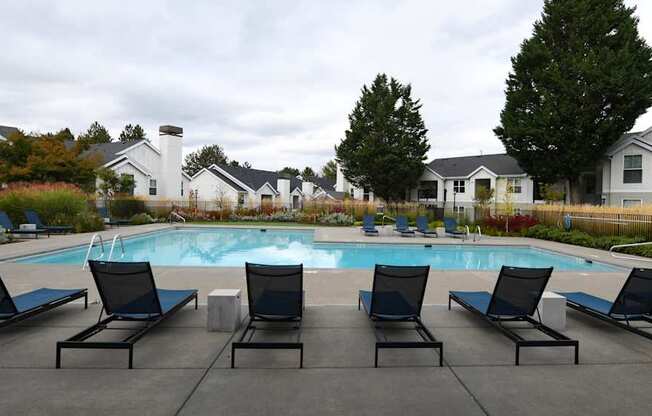 a swimming pool with black lounge