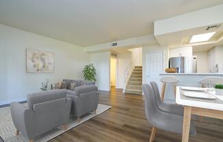 a living room filled with furniture and a wood floor