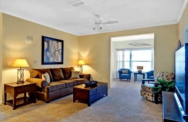 Living Room and Sunroom with yellow lights at Village on the Lake Apartments, North Carolina