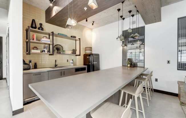 a kitchen with a long counter top and a long table