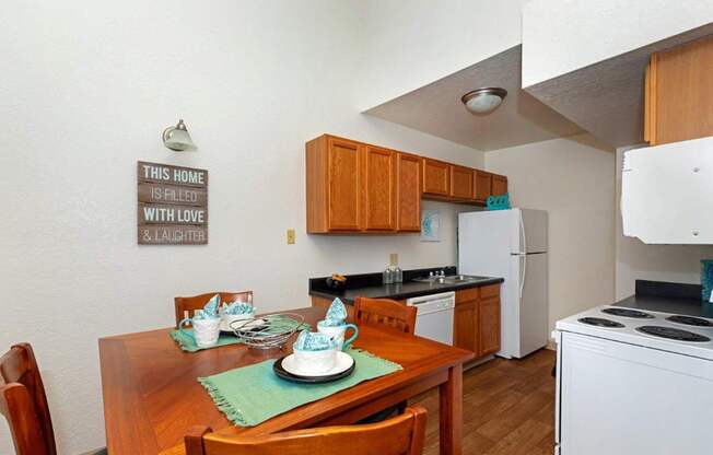 A kitchen with a sign that says "This home is filled with love and laughter.".