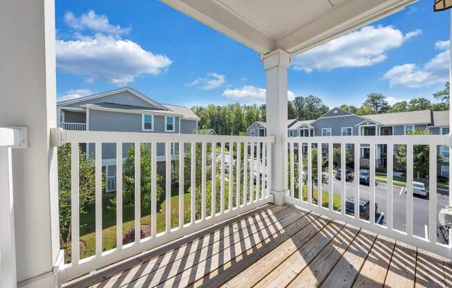 the view from the balcony of a home with a wooden deck