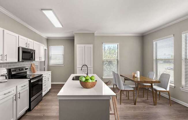 A kitchen with a table and chairs.