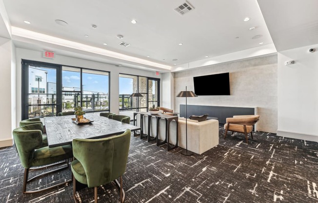 a conference room with a table and chairs and a television
