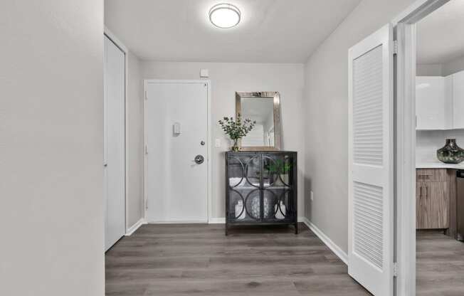 a hallway with white walls and a white door